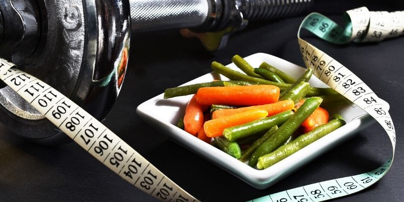 Optimal Health Quiz - tape measure, veggies, hand weight