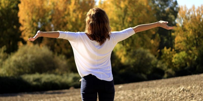 Optimal Health Quiz - woman with outstretched arms